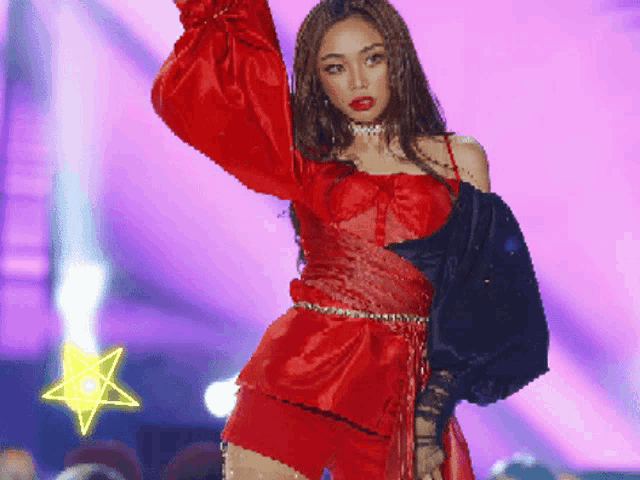 a woman in a red dress stands in front of a purple background with a star in the foreground