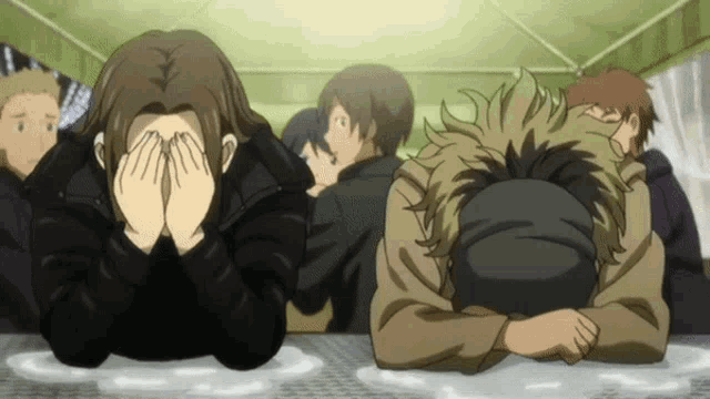 a group of people covering their faces with their hands while laying down