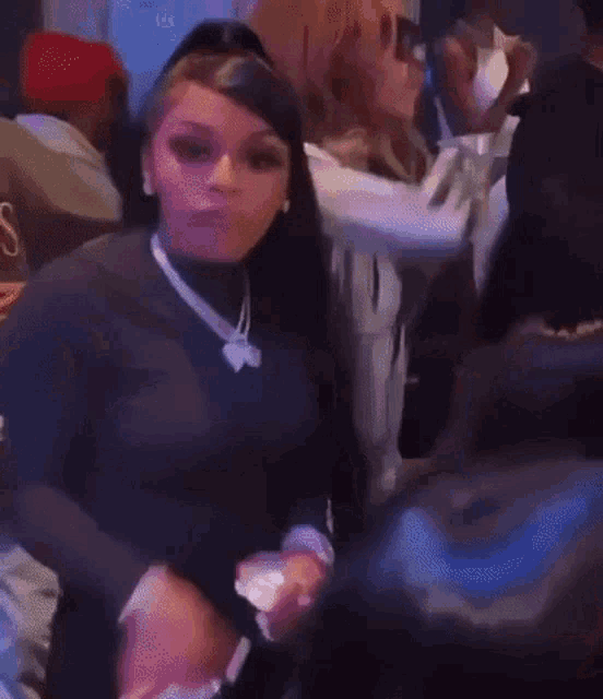 a group of people are dancing in a club .