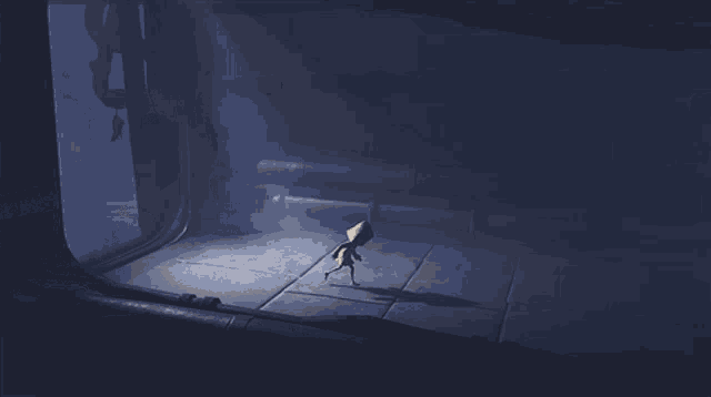 a person in a yellow jacket is walking in the dark