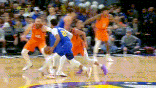 a group of basketball players are playing a game on a court .