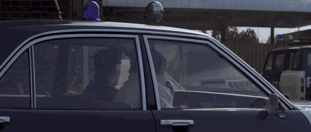 a police car with a blue light on the roof