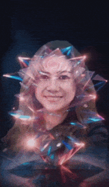 a woman 's face is surrounded by glowing triangles in a dark room