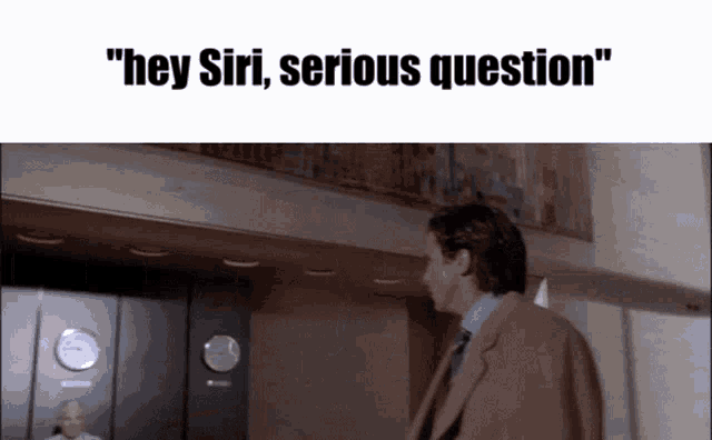 a man in a suit and tie is standing in front of an elevator with the words " hey siri serious question " above him