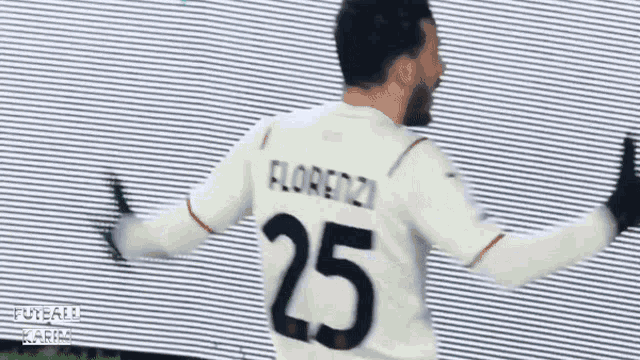 a soccer player wearing a white jersey with the number 25 on the back