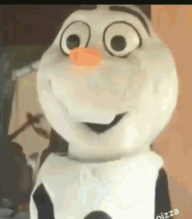 a close up of a snowman mascot with an orange nose .