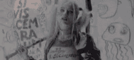 a black and white photo of a woman in a suicide squad costume .