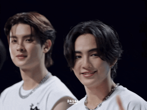two young men are standing next to each other and the number 24148 is on the bottom right