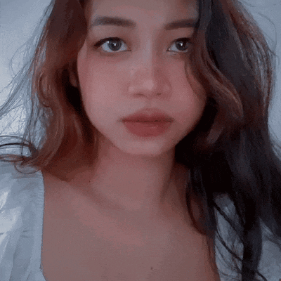 a close up of a woman 's face with a white shirt on