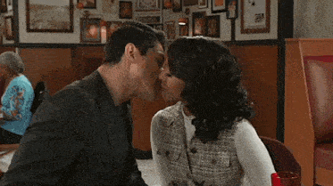 a man and a woman are kissing each other on the nose