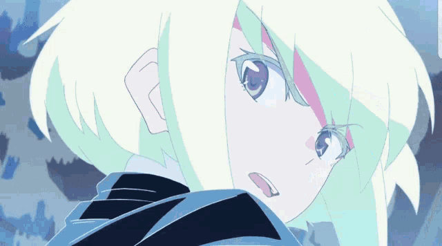 a close up of a girl 's face with a blue background