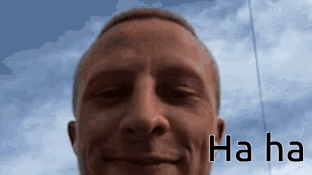 a close up of a man 's face with the words ha ha on the bottom right
