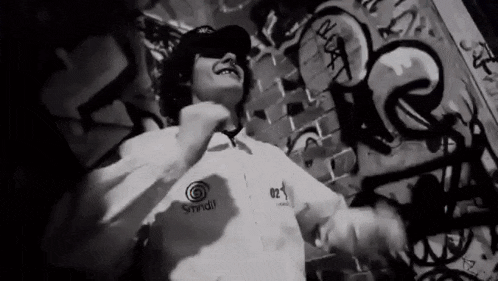 a black and white photo of a person wearing a shirt with the number 02 on the front