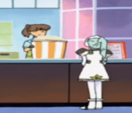 a girl in a white dress is standing in front of a counter with a bucket of popcorn