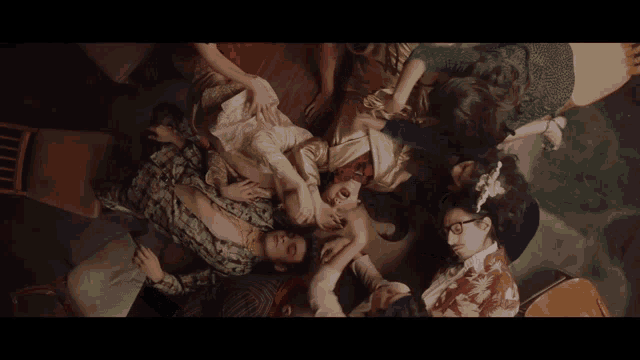 a man is laying on a woman 's lap and touching her breasts