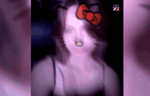 a blurred image of a woman with a hello kitty bow on her head