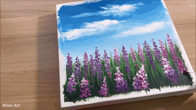 a painting of purple and white flowers on a wooden table with wow art written on the bottom