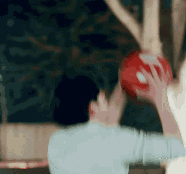 a blurry picture of a person holding a basketball in their hand .