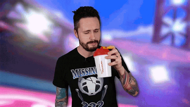 a man wearing a mission shirt holds a shaker