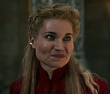 a woman with blonde hair is wearing a red coat