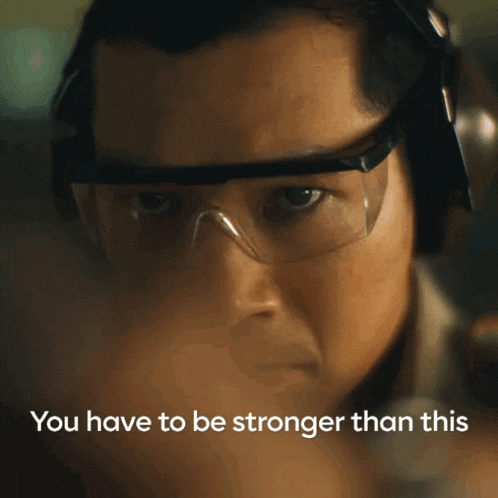 a close up of a man wearing headphones and safety goggles with the words " you have to be stronger than this "