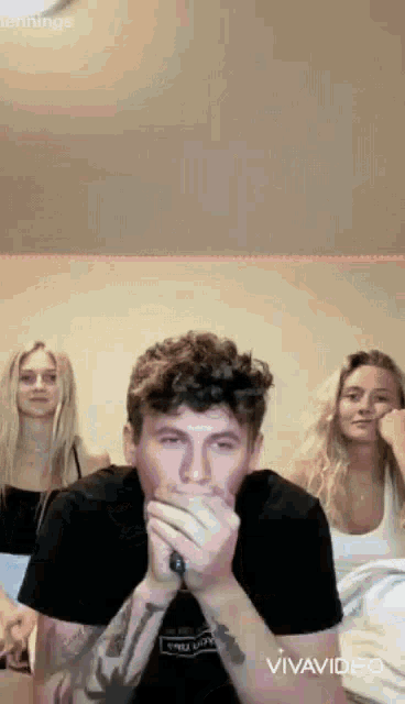 a man and two women are sitting next to each other .