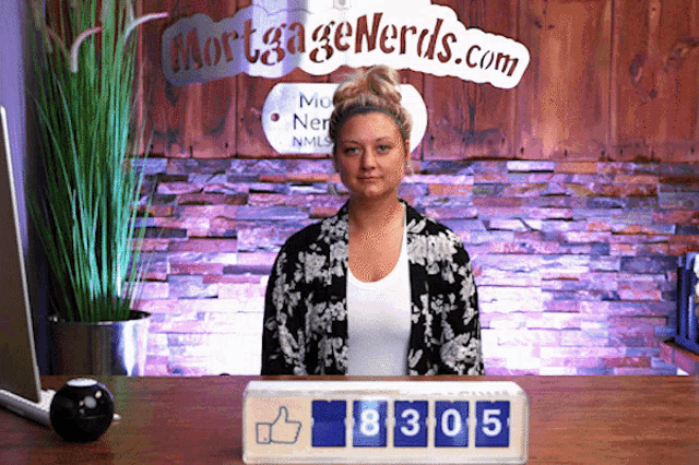 a woman sitting in front of a sign that says mortgage nerds