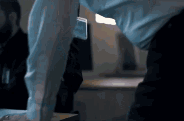 a man in a blue shirt has a name tag on his sleeve that says ' a ' on it