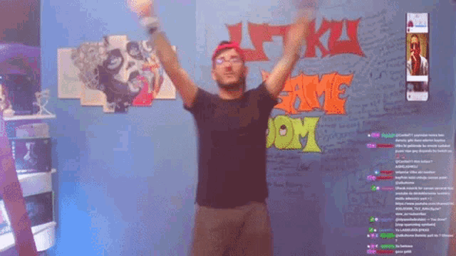 a man is dancing in front of a wall that says game look