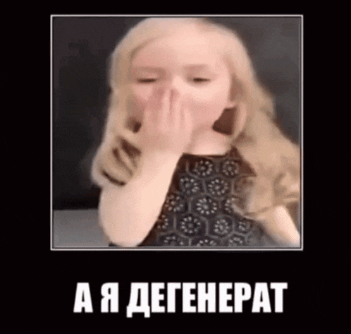 a little girl is covering her nose with her hand and making a funny face .