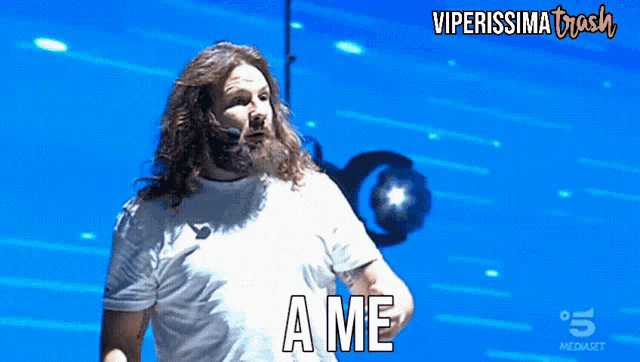a man with long hair and a beard is saying ame