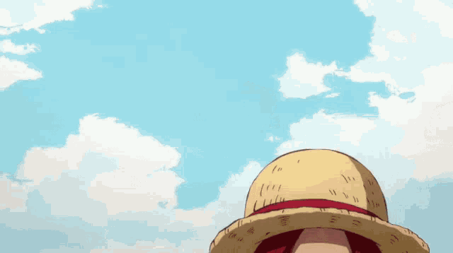 a man with red hair is wearing a straw hat against a blue sky with clouds
