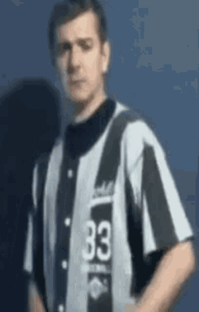 a man wearing a striped shirt with the number 33 on it .