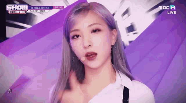 a close up of a woman 's face with a show champion logo in the background