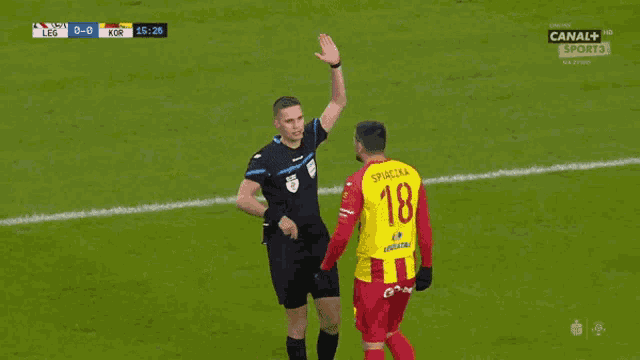 a soccer player wearing a red and yellow jersey that says suzuki
