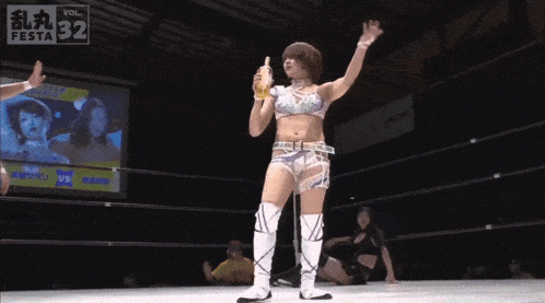 a woman in a wrestling ring holds a beer in her hand