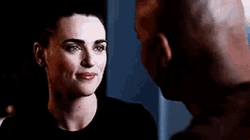 a man and a woman are looking into each other 's eyes .