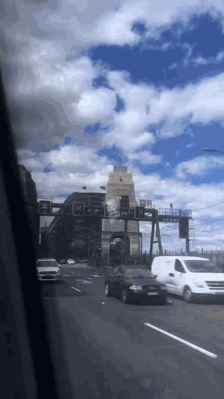 a car is driving down a highway with a red x on a traffic light