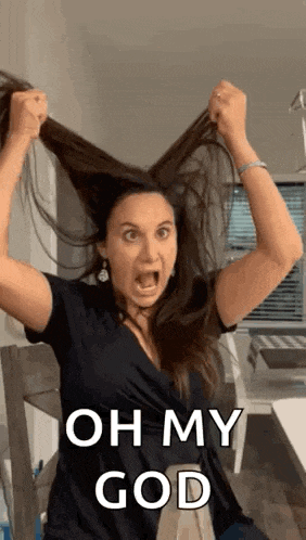 a woman is holding her hair in the air with her mouth open and the words oh my god on the bottom .