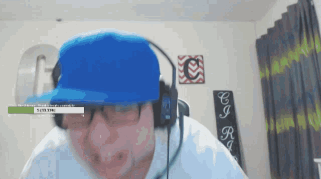 a man wearing headphones and a blue hat has a green bar above his head that says ' subscribe '