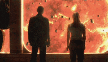 a man and a woman are standing in front of a screen with a red background