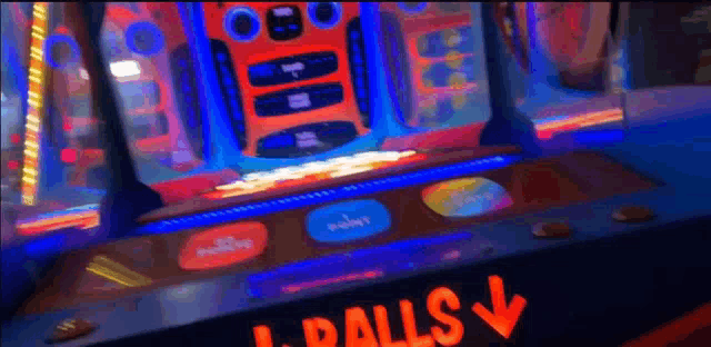 an arcade game with a red arrow pointing to the right