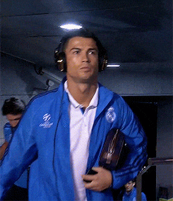 a man wearing headphones and a blue jacket with a real madrid logo on it