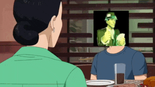 a woman is looking at a picture of a man with a green face