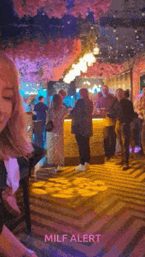 a group of people are standing in a room with a sign that says botanic on it