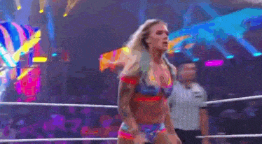 a woman is standing in a wrestling ring .
