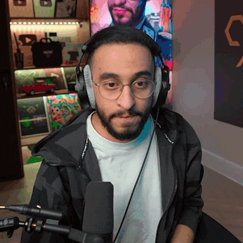 a man with a beard wearing headphones and a microphone