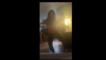 a person is dancing in a dark room with a shirt that says ' i love you ' on it .