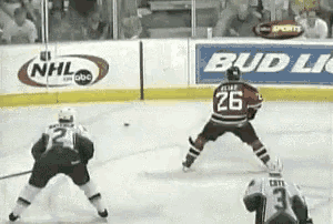 a hockey player with the number 26 on his jersey stands on the ice