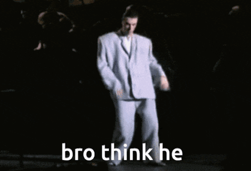 a man in a suit is dancing on a stage with the words bro think he above him
